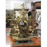 VICTORIAN BRASS CLOCK GARNIATURE, the clock with coil bar strike in ornate pierced foilate decorated