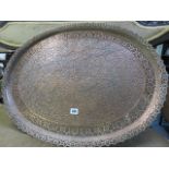 PERSIAN METALWARE, a copper pierced border and floral embossed oval tray,