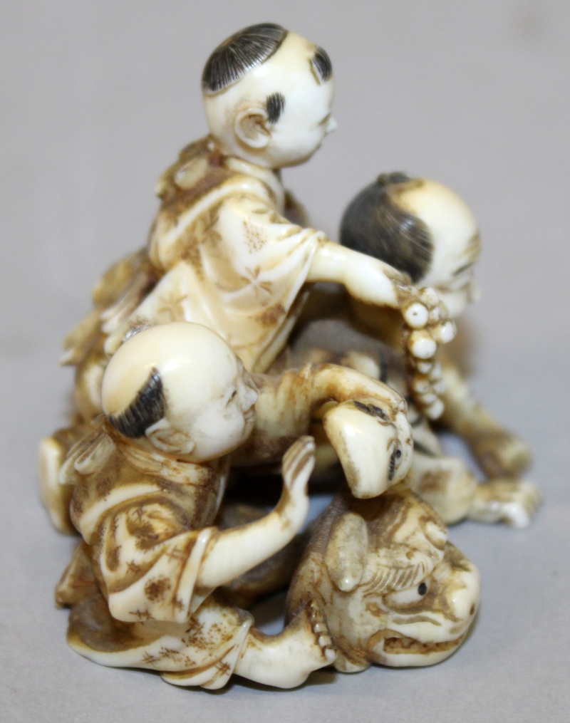 A GOOD QUALITY JAPANESE MEIJI PERIOD IVORY OKIMONO OF A MAN & TWO BOYS, one child holding grapes and - Image 2 of 5