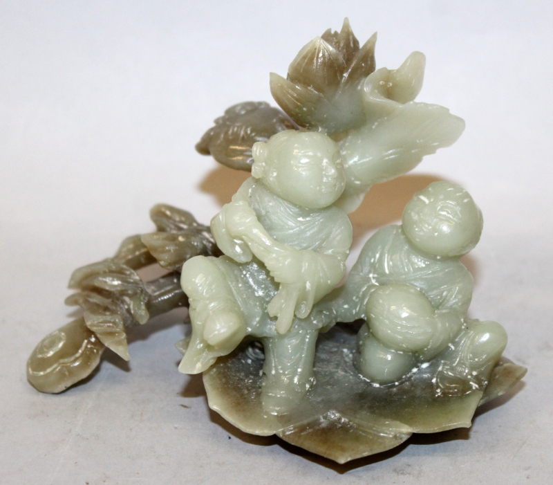 A CHINESE JADE-LIKE HARDSTONE MODEL OF THE HE HE ERXIAN, the two boys on a lotus leaf beside a