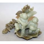 A CHINESE JADE-LIKE HARDSTONE MODEL OF THE HE HE ERXIAN, the two boys on a lotus leaf beside a