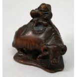 A GOOD QUALITY SIGNED JAPANESE MEIJI PERIOD BOXWOOD NETSUKE OF A BOY SEATED ON A WATER BUFFALO,