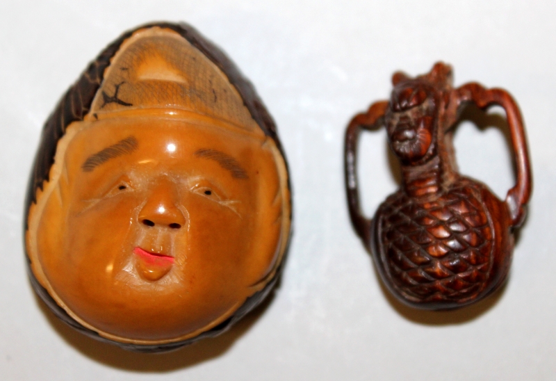 A SIGNED JAPANESE TAGUA NUT NETSUKE OF DAIKOKU, the deity's face with smiling expression, the