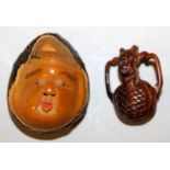 A SIGNED JAPANESE TAGUA NUT NETSUKE OF DAIKOKU, the deity's face with smiling expression, the