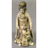 A SIGNED JAPANESE MEIJI PERIOD IVORY OKIMONO GROUP, of a geisha in the company of a young girl who