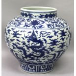 A CHINESE BLUE & WHITE MING STYLE PORCELAIN DRAGON JAR, the sides decorated between formal borders