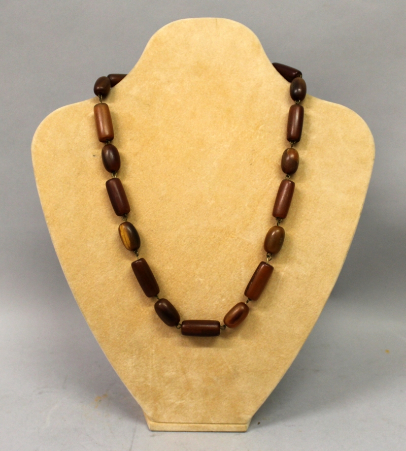 A HORN NECKLACE, comprising alternating oval and cylindrical beads, approx. 20.5in long.