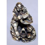 A GOOD QUALITY JAPANESE MEIJI PERIOD IVORY NETSUKE OF BENKEI BLOWING A CONCH SHELL, the deity seated