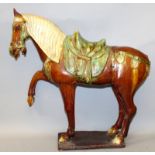 A LARGE CHINESE SANCAI TANG STYLE GLAZED POTTERY HORSE, standing on a rectangular plinth with one