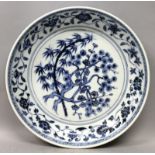 A CHINESE BLUE & WHITE MING STYLE PORCELAIN DISH, painted to the centre with the 'Three Friends',