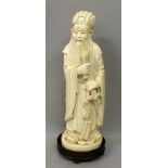 A GOOD LARGE CHINESE IVORY FIGURE OF A SAGE, the ivory weighing 1.74Kg, together with an oval wood