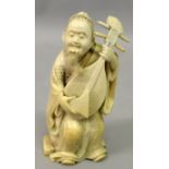 A SIGNED JAPANESE MEIJI PERIOD IVORY OKIMONO OF A MAN PLAYING A LUTE, the man seated in patterned
