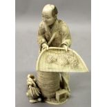 A GOOD QUALITY SIGNED JAPANESE MEIJI PERIOD IVORY OKIMONO OF A FARMER WINNOWING GRAIN, standing