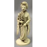 A GOOD QUALITY SIGNED JAPANESE MEIJI PERIOD OKIMONO OF A GEISHA, standing in flowing robes, her feet