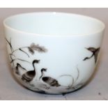 A CHINESE PORCELAIN CUP, the sides decorated with calligraphy and with a group of geese on a rocky