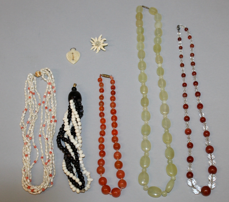 A GROUP OF FIVE BEAD NECKLACES, composed of various materials, and an ivory pendant and a brooch. (