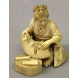 A GOOD QUALITY SIGNED JAPANESE MEIJI PERIOD IVORY OKIMONO OF A FAN MAKER, the kneeling lady