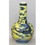 A CHINESE YELLOW GROUND BLUE & WHITE PORCELAIN BOTTLE VASE, decorated with dragons and bats amidst