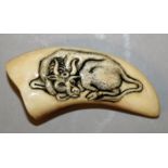 A 19TH/20TH CENTURY OWAMI SCHOOL TOOTH NETSUKE, one side carved with a recumbent water buffalo,