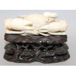 A JAPANESE MEIJI PERIOD IVORY CARVING OF A CRAB, together with a fitted wood stand, the eyes of