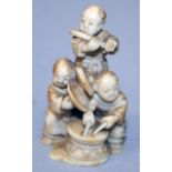 A SIGNED JAPANESE MEIJI PERIOD NETSUKE OF A GROUP OF BOY MUSICIANS, playing various instruments, one