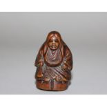 A GOOD JAPANESE EDO/MEIJI PERIOD BOXWOOD & IVORY NETSUKE OF A SHOJO, unsigned, standing in