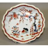 AN 18TH CENTURY WORCESTER SAUCER DISH in Chinese Export style and a shaped dish painted with the two