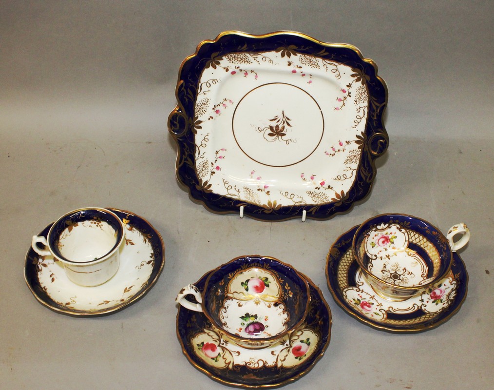 A 19TH CENTURY COALPORT STYLE THREE FLORAL CUPS AND SAUCERS and a floral tray.