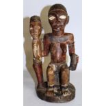 AN AFRICAN CARVED WOOD DOUBLE FIGURE. a seated mother and standing child.  12ins high.