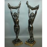 A GOOD PAIR OF ART DECO CHROME BRONZE CLASSICAL STANDING FEMALE FIGURES holding aloft garlands.