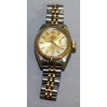 A LADIES ROLEX GOLD AND SILVER DAY DATE WRISTWATCH in Rolex box.