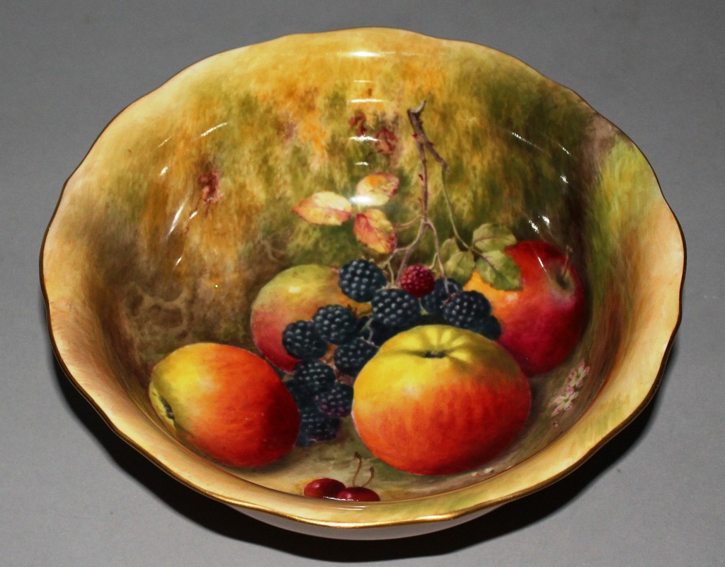 A ROYAL WORCESTER BOWL with shaped rim, hand painted with apples, blackberries and cherries under