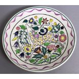 A POOLE POTTERY CIRCULAR DISH by N. BLACKMORE, colourful deer. Signed on reverse.  10.25ins