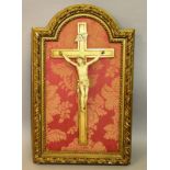 AN 18TH CENTURY ITALIAN CARVED IVORY CORPUS CHRISTI mounted in a wooden frame. 7.5ins.