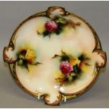 A ROYAL WORCESTER PLATE, finely painted with roses under a coloured clay border in Hadley style,