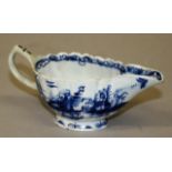 AN 18TH CENTURY BOW CREAM BOAT painted in under-glaze blue with a chinoiserie scene.