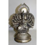 A SILVERED METAL BUDDHA on an oval base. 10ins high.