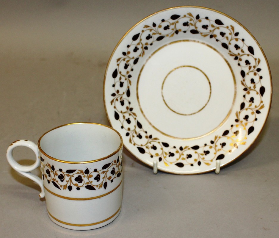 AN EARLY 19TH CENTURY FLIGHT BARR WORCESTER COFFEE CAN AND SAUCER with trailing brown and gilt