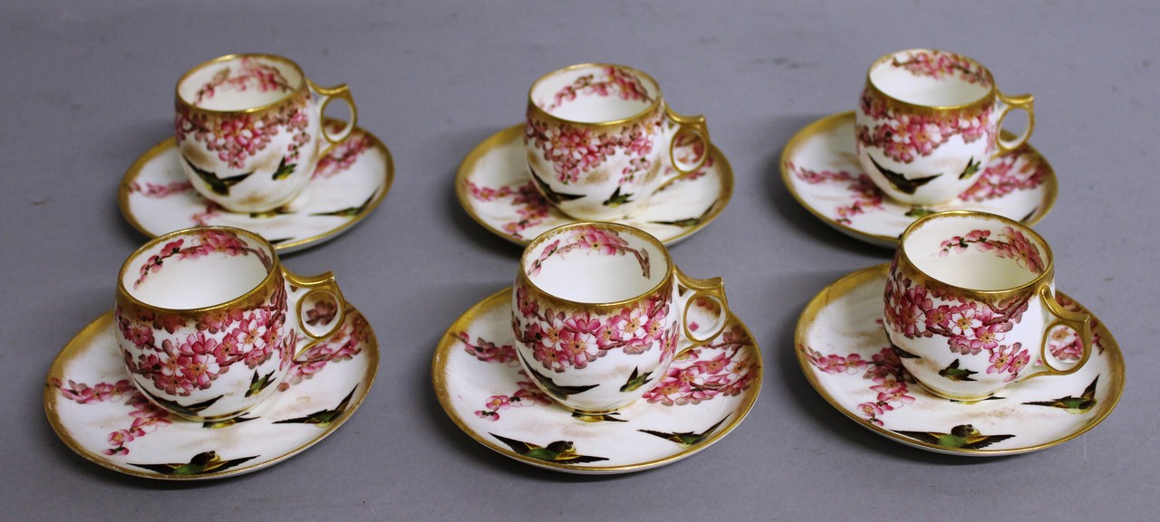 A  SET OF SIX GEORGE JONES COFFEE CUPS AND SAUCERS, birds and bloom pattern.