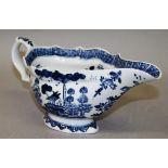 AN 18TH CENTURY BOW SAUCEBOAT painted in blue underglaze with a house in a Chinese landscape.