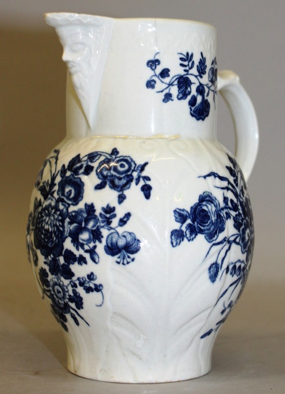 AN 18TH CENTURY WORCESTER CABBAGE LEAF MOULDED MASK JUG decorated with flowers and a rare small