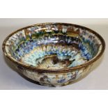 A STONEWARE STUDIO POTTERY BOWL with splash decoration. 9.5ins diameter.