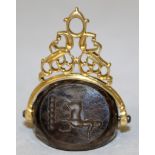 A GEORGIAN GOLD MOUNTED SWIVEL FOB, the three-sided smoky quartz intaglio with incised armorial