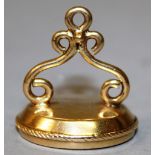 A GOLD MOUNTED FOB SEAL, the oval cornelian intaglio incised with a crest beneath motto "FIDE ET