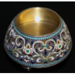 A RUSSIAN SILVER AND ENAMEL CIRCULAR SALT on four circular bun feet, 8.5cms diameter, Maker: PAVEL