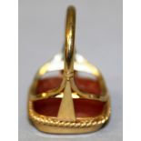 A 9CT GOLD MOUNTED RING, collet set with a rounded rectangular cornelian intaglio, crested and