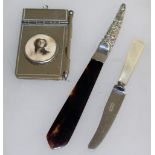 A SILVER PAPERKNIFE with silver handle, another with mother-of-pearl handle and a notebook (3).