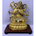 A LARGE GOOD QUALITY SINO-TIBETAN GILT BRONZE FIGURE OF MAHAKALA, together with a hardwood stand,