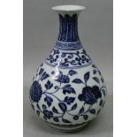 A CHINESE MING STYLE BLUE & WHITE PORCELAIN VASE, the sides of the pear-form body decorated with