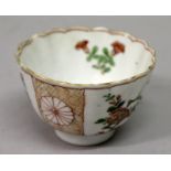 A CHINESE KANGXI PERIOD FAMILLE VERTE FLUTED PORCELAIN TEABOWL, circa 1700, the sides painted with